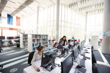 Students in a library demonstrate how technology is advancing accessibility at scale.
